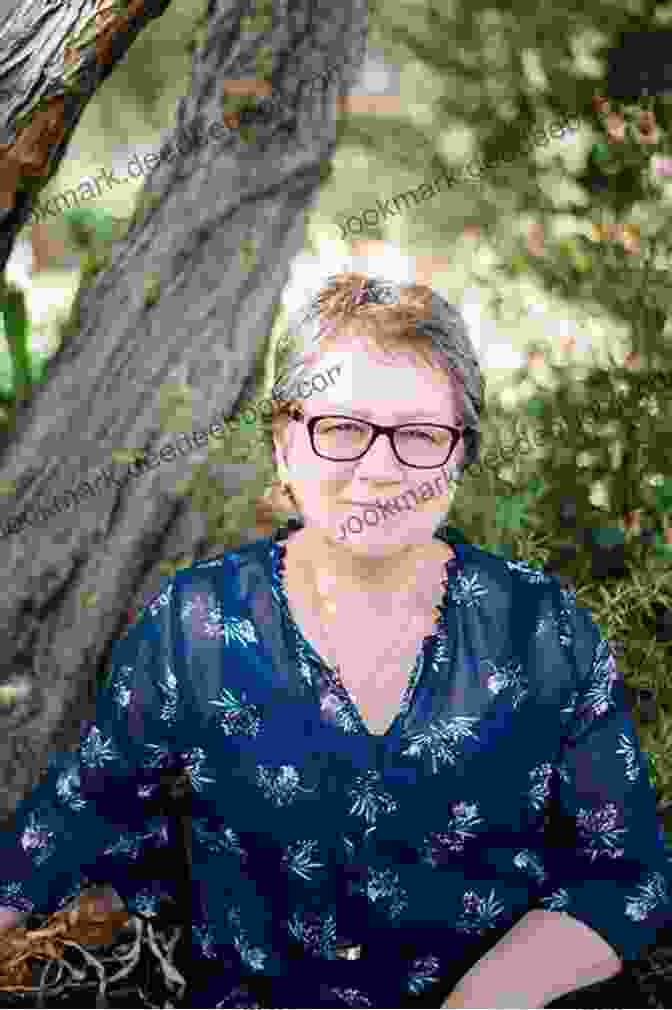 Emelin Jackie Randall Portrait, A Woman With Short Hair And A Warm Smile, Wearing A Patterned Shirt. Emelin Jackie Randall